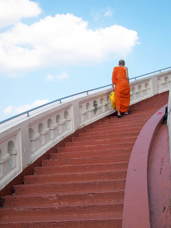 BANGKOK, THAILAND - November 12  priest walking up stairs at Wat Saket ,on Novemver 12,2011 in Bangkok,Thailand のeditorial素材
