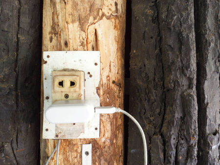 outlet and switch on the wooden wall 