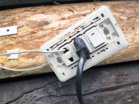 outlet and switch on the  wooden wall 