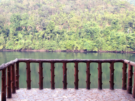 Railing of walkway beside riverの写真素材