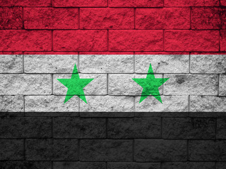 Flag of Syria painted onto a grunge brick wallの写真素材