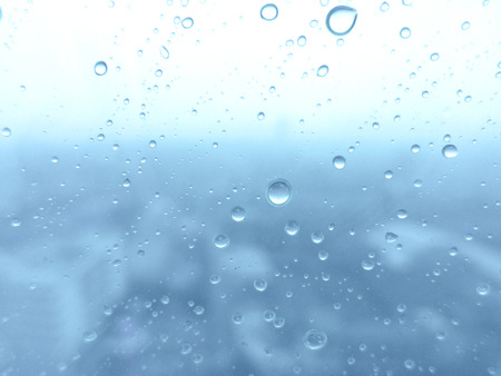 Close-up of water drops on glass surface as backgroundの写真素材