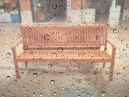 close up drops of rain on glass background. chair out of focusの写真素材
