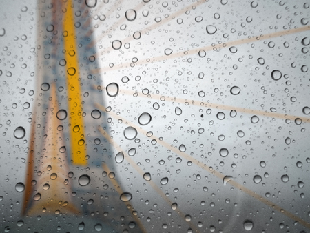 close up drops of rain on glass background. bridge out of focusの写真素材