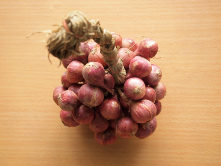 Red onions on the wooden table