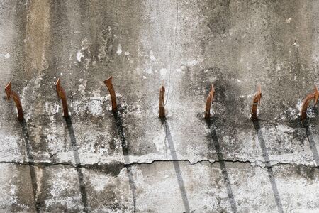sharp steel spikes on concrete wallの写真素材