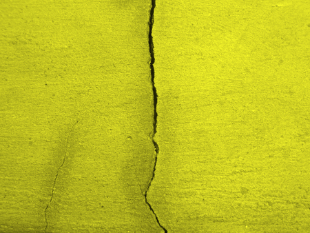 yellow cracked wall backgroundの写真素材