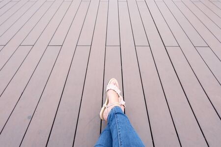 Womans legs on wood background relaxing