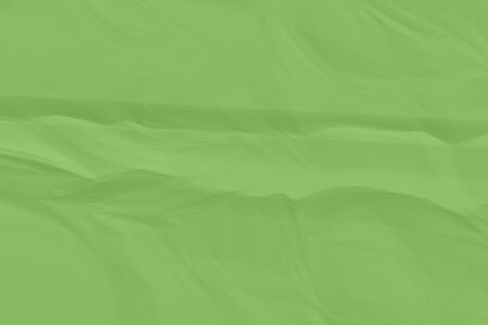 crumpled green paper background close upの写真素材