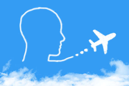 plane and head cloud shape on blue skyの写真素材