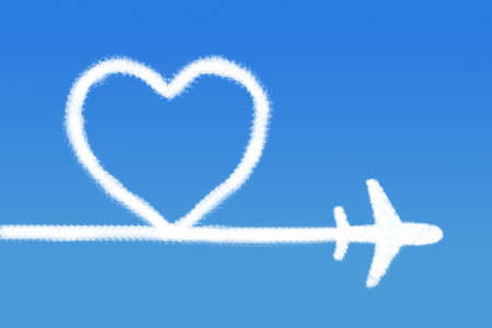 Heart shape cloud with plane on blue skyの写真素材
