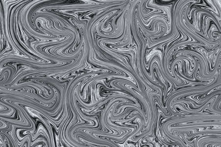 Liquid black and white paint on white paper abstract backgroundの写真素材