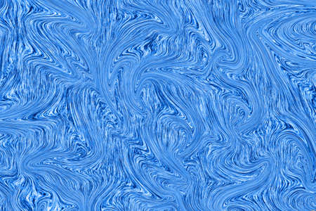 Liquid blue paint on white paper abstract backgroundの写真素材