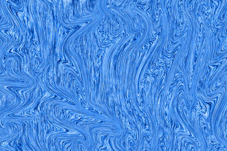 Liquid blue paint on white paper abstract backgroundの写真素材