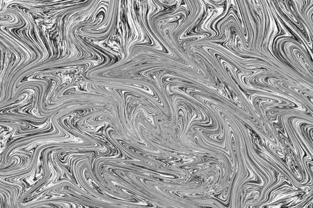 Liquid black and white paint on white paper abstract backgroundの写真素材