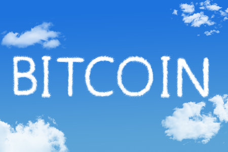 bitcoin cloud shape on blue skyの写真素材
