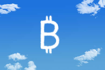 bitcoin cloud shape on blue skyの写真素材