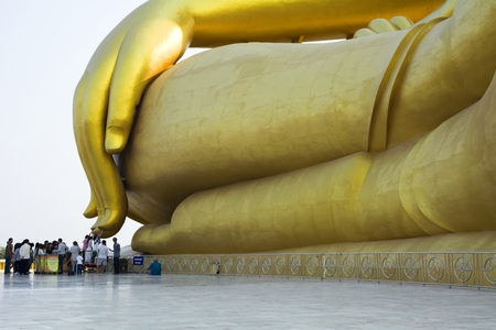 Ang Thong, Thailand - March 5, 2017: que of people to touch huge finger of giant buddha to pay respect and request for lucky.のeditorial素材