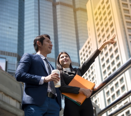 Two Business Colleagues Standing Outdoors at Office Buildingの写真素材