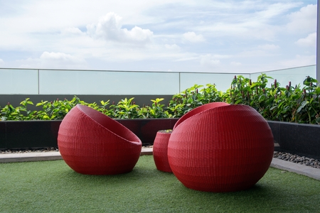 Red Rattan Arm Chair at Coister of Condiminiumの写真素材
