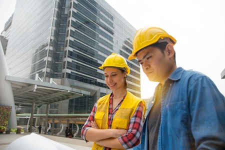 Team of architectures standing at construction site looking at progress.の写真素材