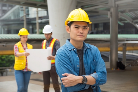 Team of architectures standing at construction site looking at progress.