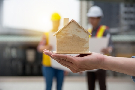 Financial concept - plan to construct residence with architecture and enginner in backgroundの写真素材