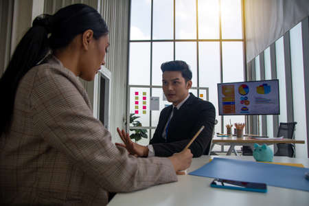 Boss talk to his secretary in office. Boss gives brief description and plan on how to accomplish the target.の写真素材