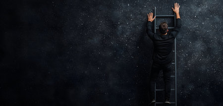 A man in a black outfit climbs a ladder towards a starry night sky, immersed in exploration and aspiration. The background adds depth, creating a profound atmosphere.の素材