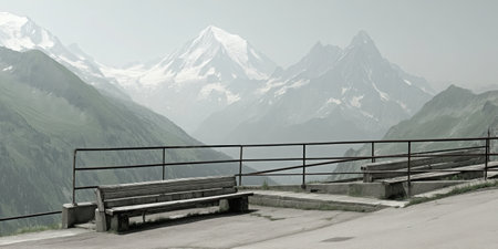This serene image captures a scenic overlook featuring benches surrounded by majestic mountains in a foggy atmosphere. Perfect for evoking a sense of calm.の素材