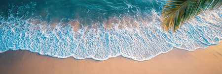 A breathtaking aerial view capturing gentle waves washing ashore on a sandy beach, showcasing the tranquil beauty of summer. The clear turquoise water invites relaxation and peace.の素材