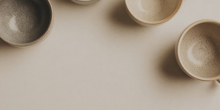 A collection of minimalist ceramic bowls gracefully arranged on a soft neutral background. Perfect for interior design, decor inspiration, or culinary presentations.の素材