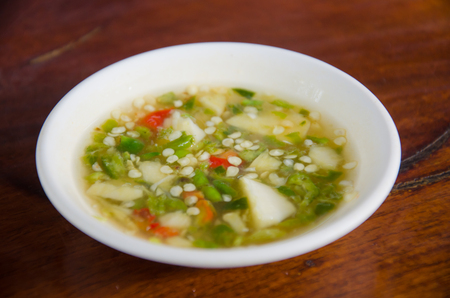 Thai flavor dipping fish sauce, chili, lime and garlic on wood tableの写真素材