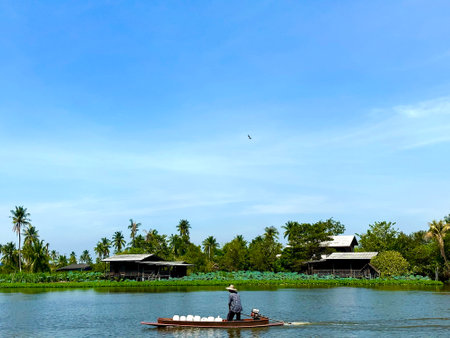 Unidentified man rowing boat on the river in Ratchaburi, Thailand.の写真素材