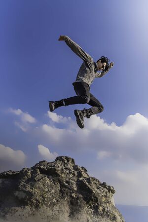 man jumping on the mountainの写真素材