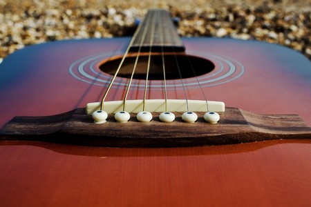 closeup on the guitar bridge with bridge pinsの写真素材