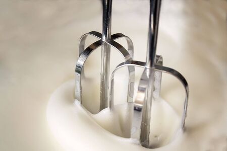 Egg-beater making whisked egg-whitesの写真素材
