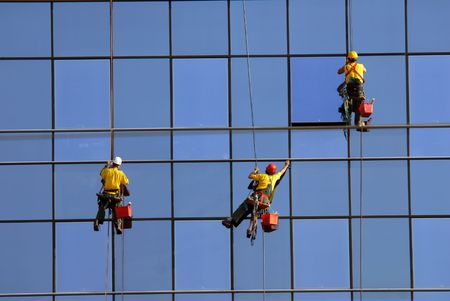 Men washing windows at height, modern skyscraperの写真素材