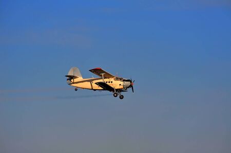 Airplane spraying, horisontal image, blue sky with copy space