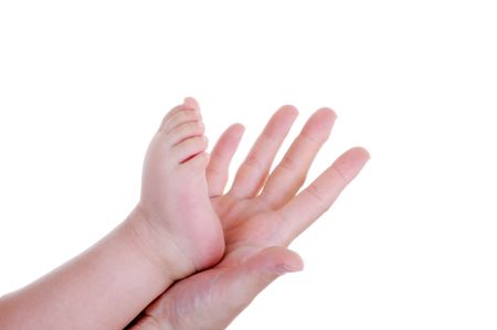 Mother holding her baby foot in hand, studio shot, original file RAWの写真素材