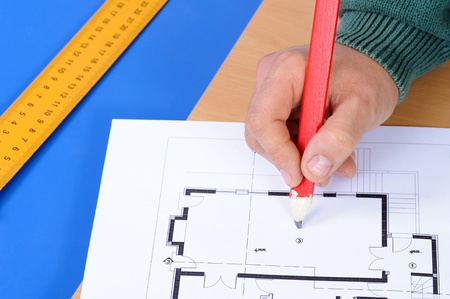 Cropped hand of a carpenter taking measurement