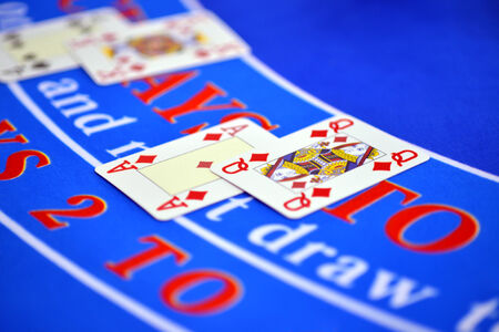 Playing cards, Ace and Queen over gambling table