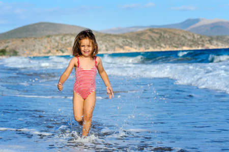 Smiling toddler girl at beachの写真素材