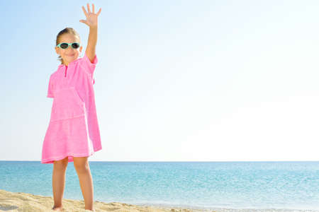 Adorable girl dancing on the beachの写真素材
