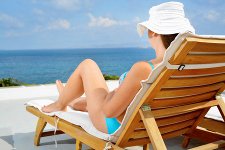 Real attractive female relaxing on the sunbedの写真素材