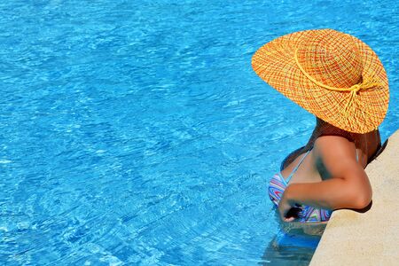 Real female beauty enjoying her summer vacation at swimming poolの写真素材
