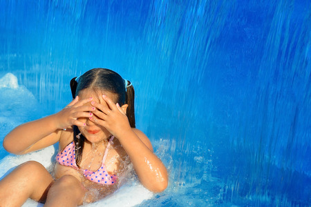Real toddler girl at swimming pool, summer vacation concept