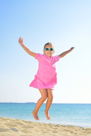 Adorable toddler girl at beach, summer vacation conceptの写真素材