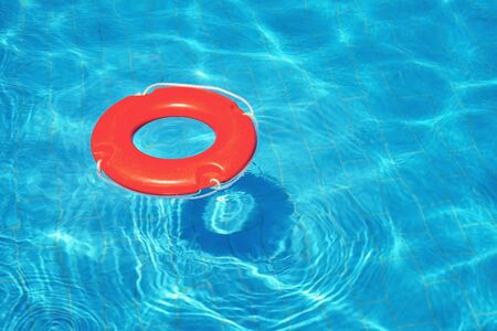 Colorful lifeguard tube floating in swimming pool, summer vacation conceptの写真素材