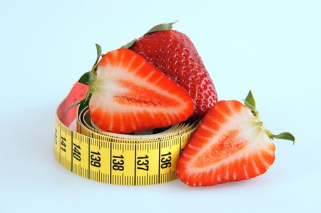 Fresh red tasty strawberries with measuring tapeの写真素材